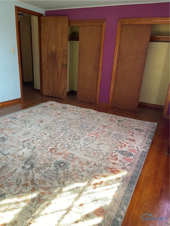 unfurnished bedroom featuring hardwood / wood-style flooring