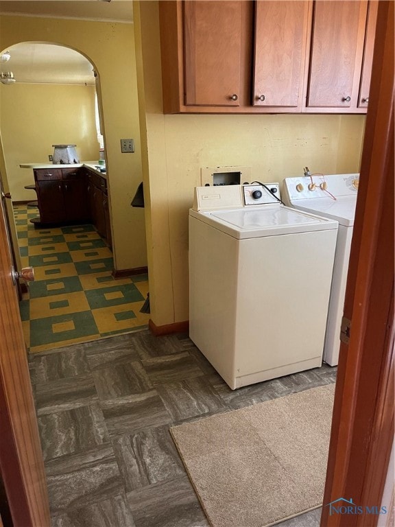 laundry room with cabinets and washer and clothes dryer