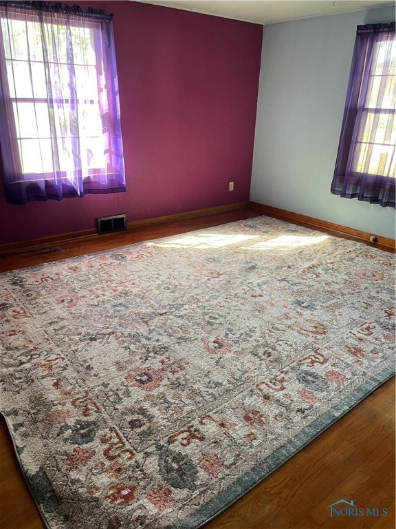 spare room with wood-type flooring