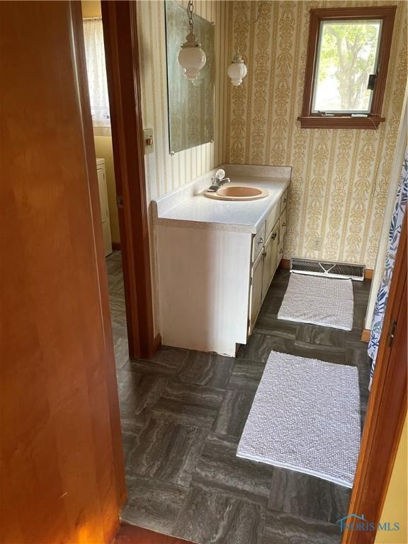 bathroom with vanity and parquet floors