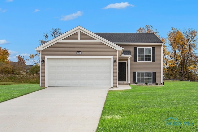 view of front of property featuring a garage and a front lawn