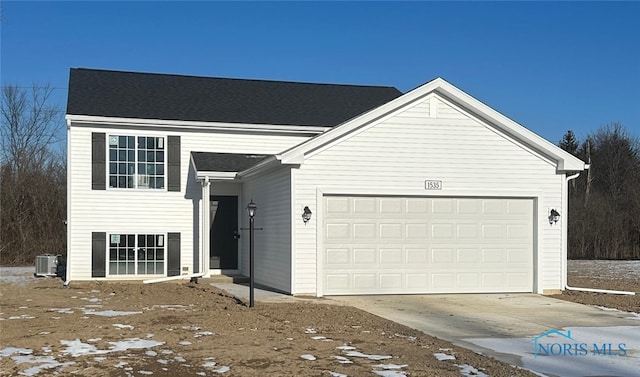 view of front facade with central AC unit and a garage