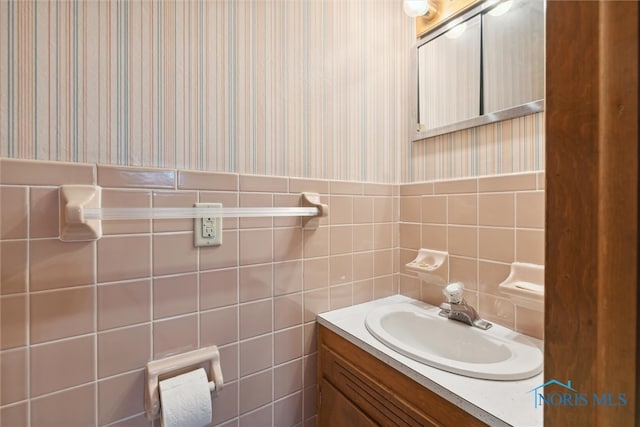 bathroom with vanity and tile walls