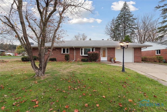 ranch-style home with a garage and a front lawn