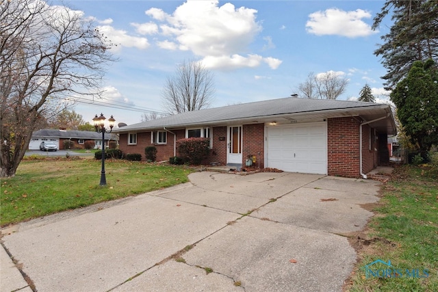 ranch-style home featuring a garage and a front lawn