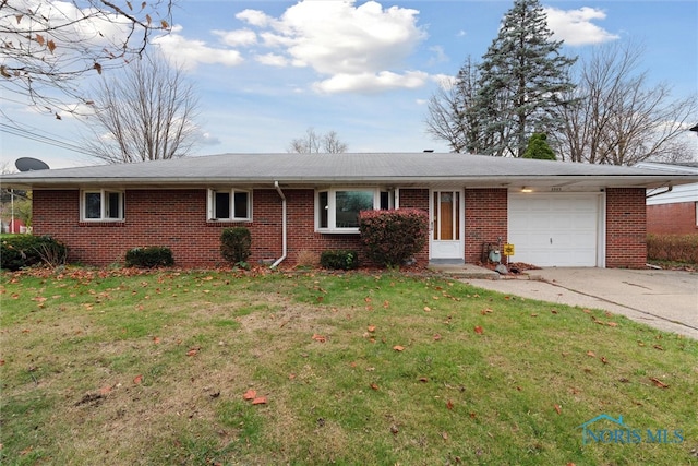 ranch-style home with a garage and a front lawn