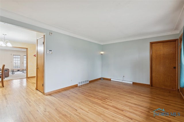 spare room featuring a notable chandelier, ornamental molding, a baseboard radiator, and light hardwood / wood-style flooring