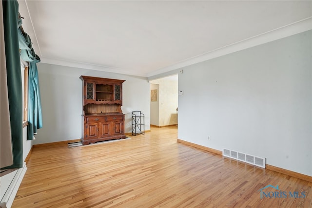 living room featuring light hardwood / wood-style flooring and ornamental molding