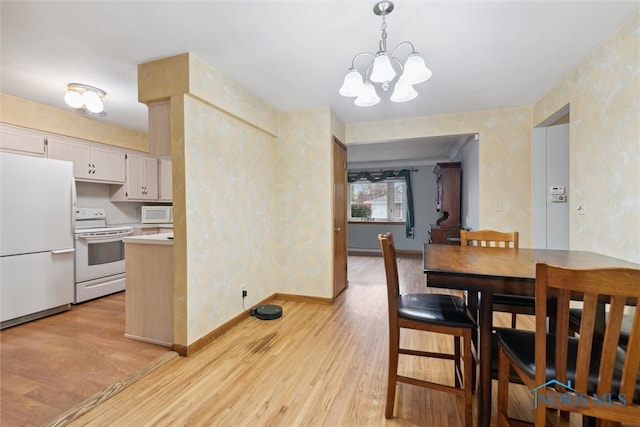 dining space featuring a notable chandelier and light hardwood / wood-style flooring