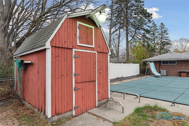 view of outbuilding featuring a covered pool