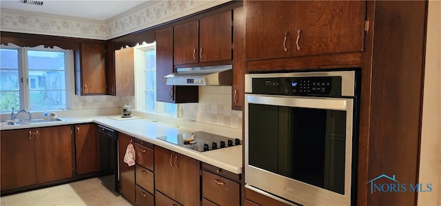 kitchen with black appliances, sink, decorative backsplash, light tile patterned flooring, and dark brown cabinetry