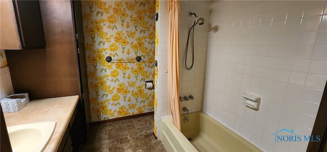 bathroom featuring vanity and tiled shower / bath combo