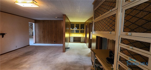 interior space featuring a textured ceiling and wooden walls