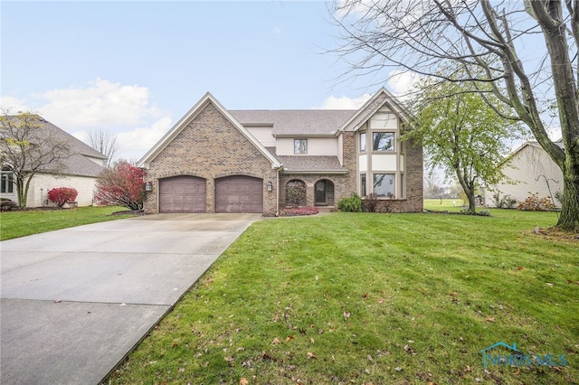 view of front of house with a front yard and a garage