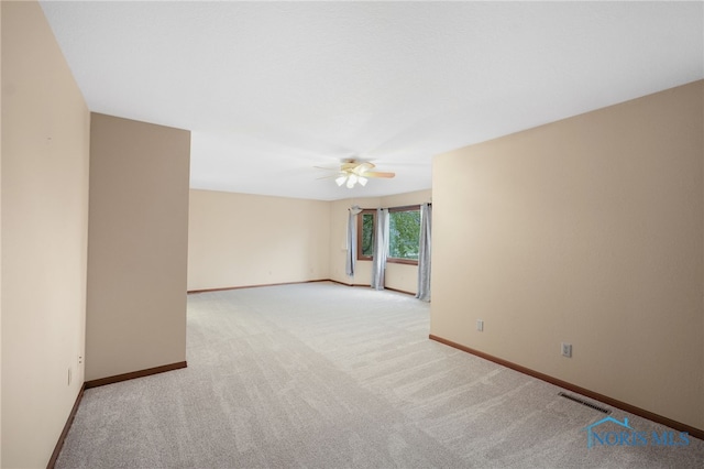 unfurnished room featuring ceiling fan and light colored carpet