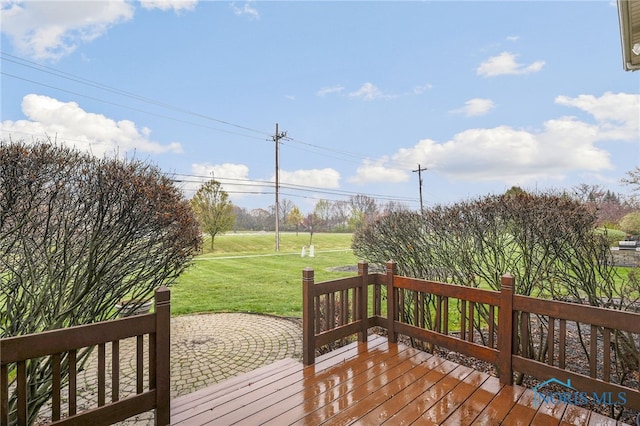 wooden deck featuring a yard