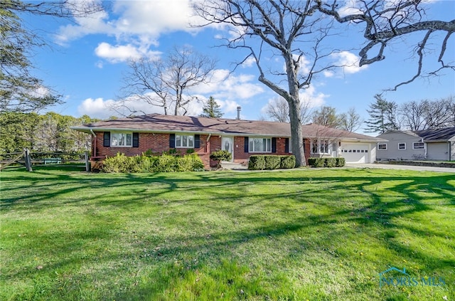 single story home with a garage and a front lawn