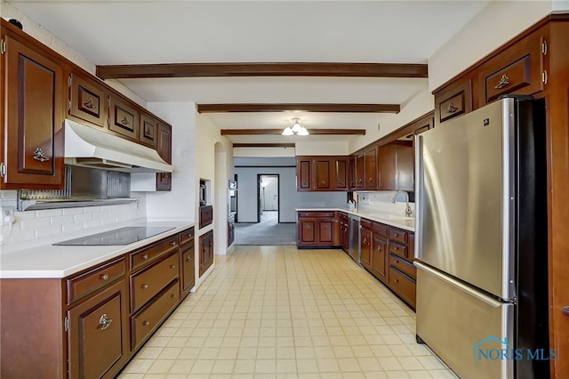 kitchen featuring beam ceiling, tasteful backsplash, sink, and stainless steel appliances