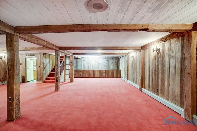 basement with carpet flooring, a baseboard radiator, wooden walls, and wood ceiling