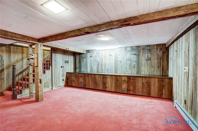 basement with wood walls and a baseboard heating unit