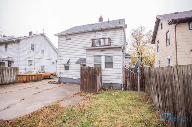 rear view of property with a balcony