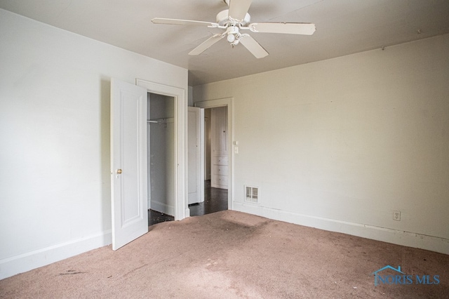 unfurnished bedroom with ceiling fan, a closet, and carpet