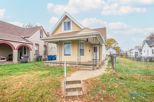 view of front of home featuring covered porch and a front lawn