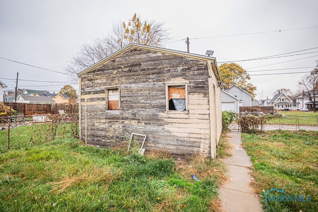 view of side of property featuring an outbuilding