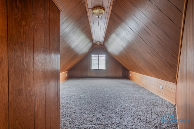 bonus room with carpet, wooden ceiling, vaulted ceiling, and wooden walls