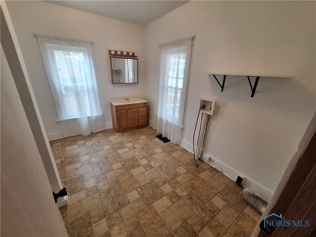 laundry area featuring a wealth of natural light, hookup for a washing machine, and sink