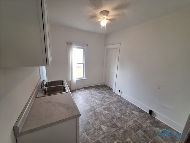 kitchen featuring ceiling fan and sink