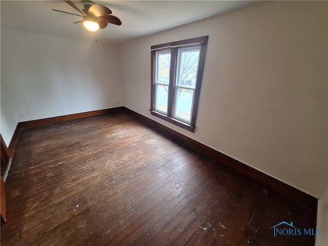 unfurnished room featuring dark hardwood / wood-style floors and ceiling fan