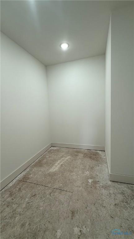 spare room with baseboards