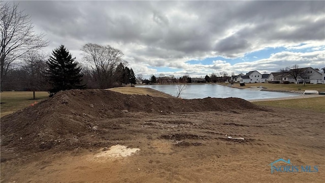 entry to storm shelter with a water view and a yard