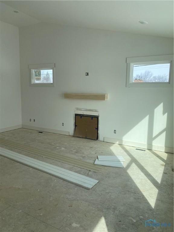 unfurnished living room with lofted ceiling