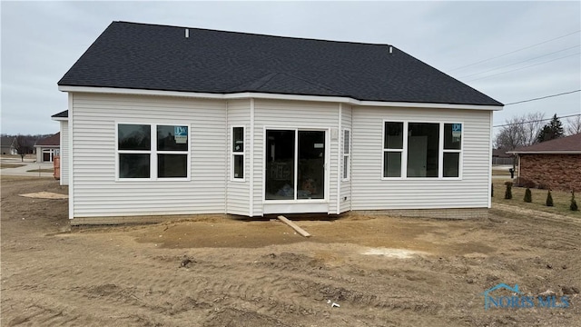 back of property featuring a shingled roof