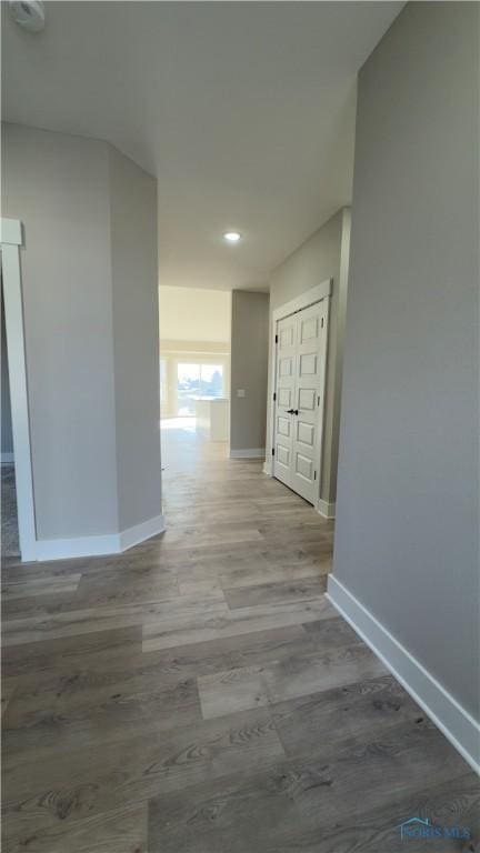 hall with wood finished floors and baseboards