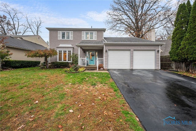 front facade featuring a garage and a front lawn