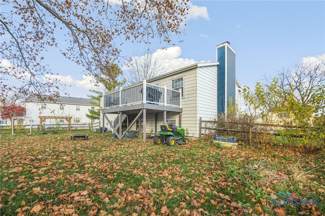 rear view of property featuring a deck