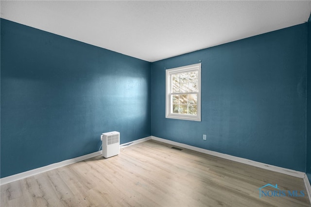 unfurnished room featuring light hardwood / wood-style flooring