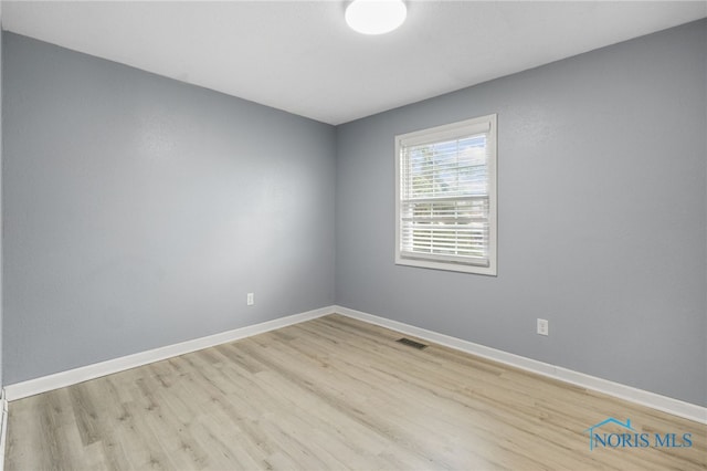 spare room with light hardwood / wood-style floors