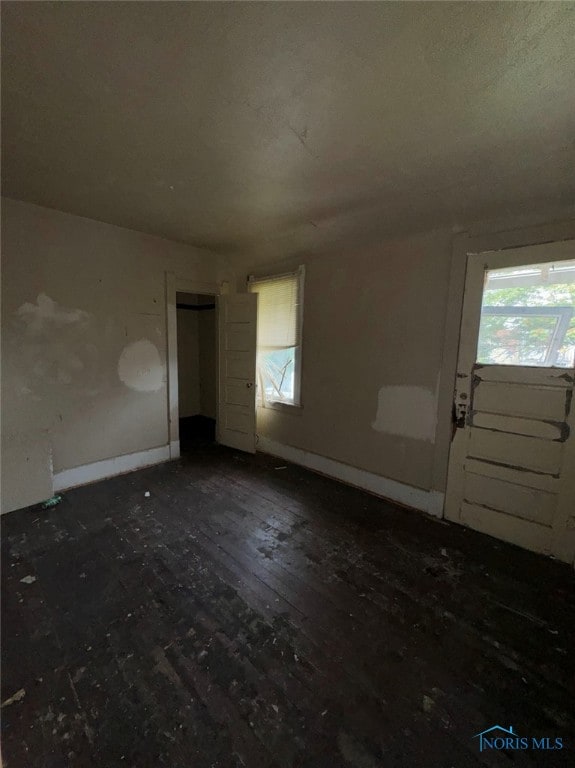 spare room featuring dark wood-type flooring