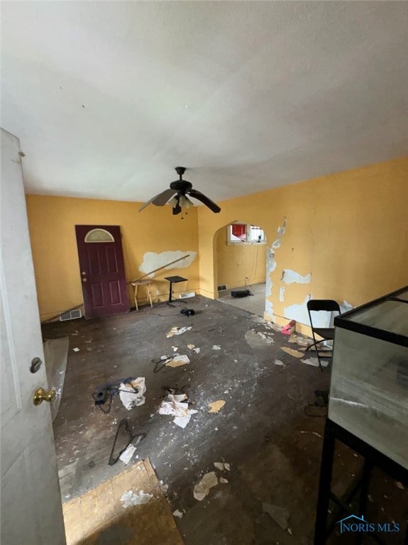 unfurnished living room with ceiling fan