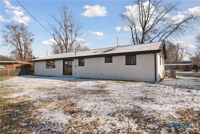 rear view of property featuring central AC unit