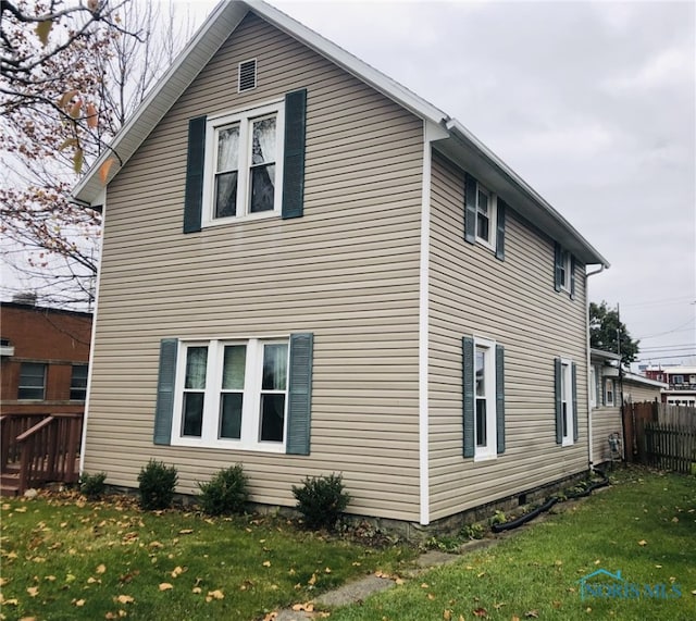 view of side of home with a lawn