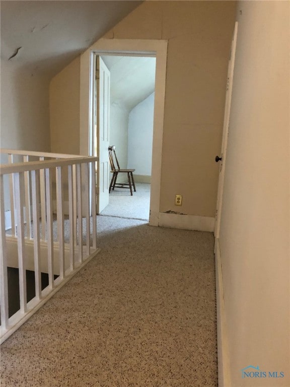 hallway featuring vaulted ceiling