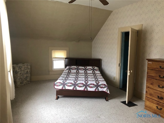 carpeted bedroom featuring ceiling fan and lofted ceiling