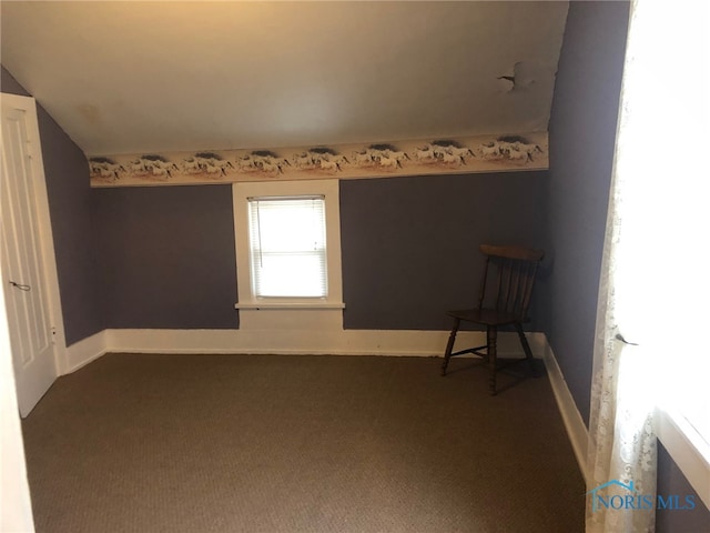 unfurnished room featuring carpet floors and lofted ceiling