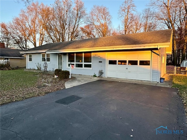 ranch-style home featuring a garage