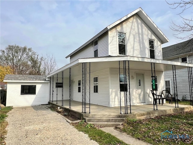 view of front of house featuring an outbuilding and a porch